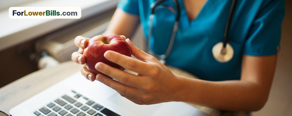 Nurse sitting at a desk with a laptop